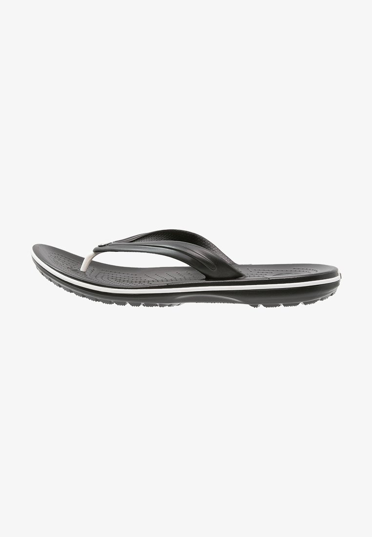 Svarte flip-flop sandaler med en teksturert såle og en glatt stropp. Har en hvit aksentlinje langs sålen. Lett design for komfort.