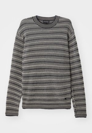 Black and cream patterned knit sweater with long sleeves and a crew neck, featuring a textured design of vertical lines.