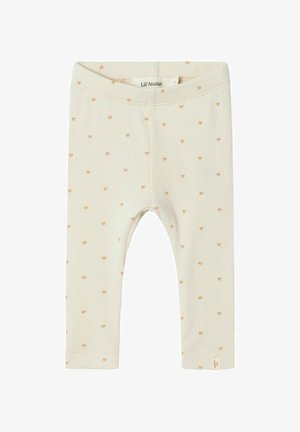 Világos bézs leggings ribbelt textúrával, apró narancssárga szívmintákkal. Rugalmas derékpánt, márkás címkével az alján.