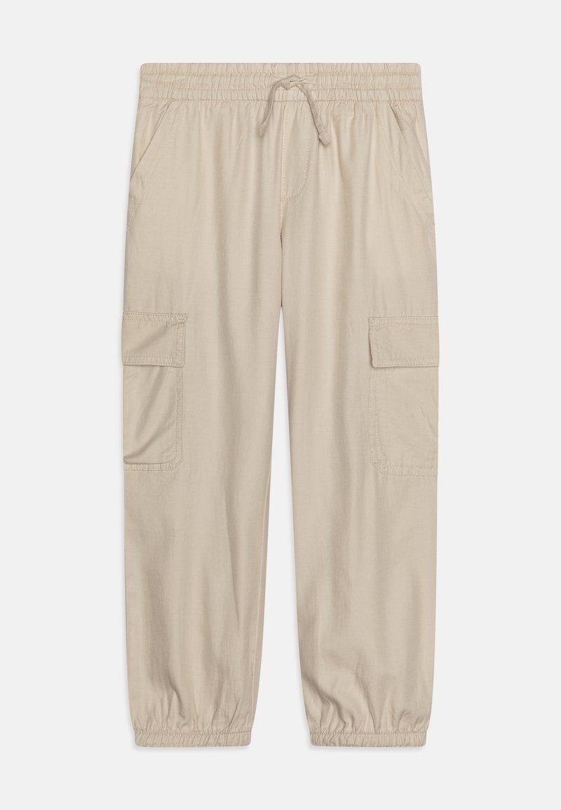 Pantalon cargo beige avec taille élastique, cordon de serrage, poches latérales, poches à rabat sur les cuisses et poignets élastiques aux chevilles.