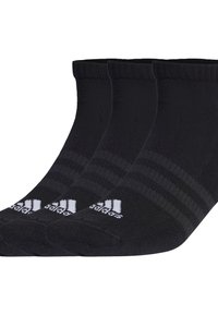 Chaussettes noires en coton jusqu'à la cheville avec trois motifs de rayures blanches et un logo blanc sur le pouce. Texture douce et bord côtelé.