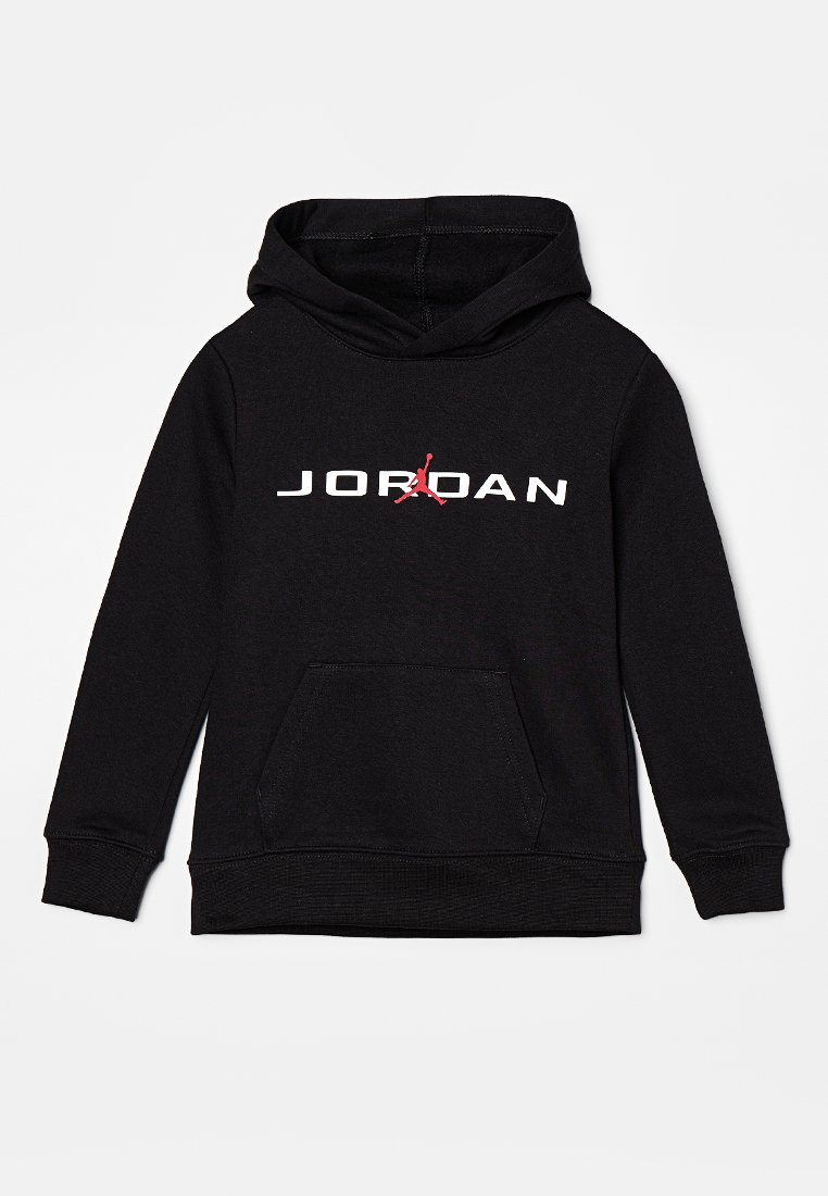Black hoodie made of cotton with a front pocket. Features white "JORDAN" text and a red Jumpman logo on the chest. Standard fit, long sleeves.