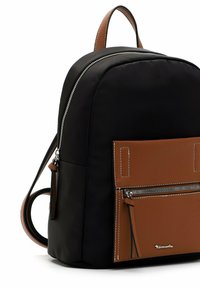 Black backpack with a brown front pocket featuring a horizontal zipper and white stitching, and a brown top handle.