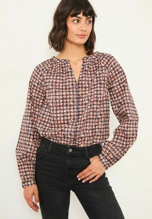 Langärmlige Bluse aus leichtem, gemustertem Stoff. Mit einem V-Ausschnitt, gerafften Details und floralen Designs in Pink, Blau und Creme.