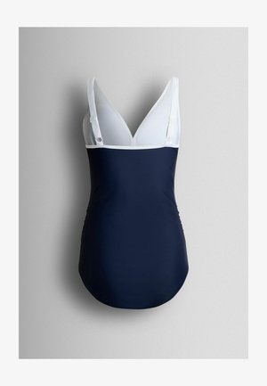 Navy blue one-piece swimsuit with white adjustable straps and deep V neckline, displayed against a gray background.
