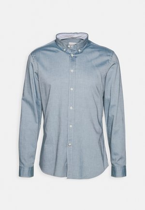 Himmelblaues, schlank geschnittenes Langarmhemd mit Button-Down-Kragen und weißen Knöpfen an der Vorderseite und den Manschetten, auf einem weißen Hintergrund präsentiert.