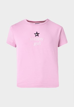 Pink short-sleeve t-shirt made of soft fabric, featuring white "tommy" text and a black star accent above the word "girl." Simple design.