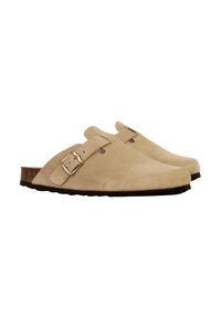 Sabots en daim beige à enfiler avec deux sangles réglables et une boucle en or, présentant un maître-semelle en liège texturé et une semelle extérieure en caoutchouc noir.