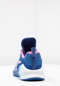 Blue athletic shoe with pink accents and a textured mesh upper. Features a padded heel tab and a white sole with a streamlined design.