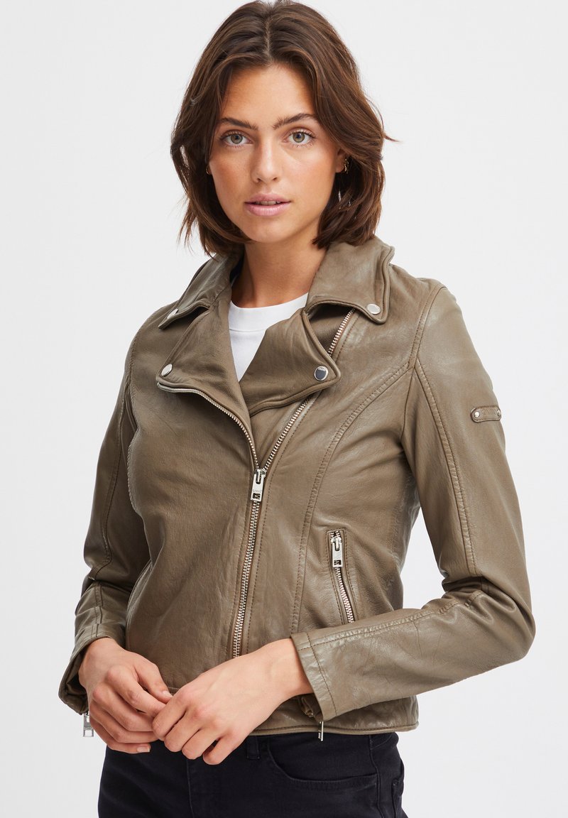 Olive green leather motorcycle jacket with a notched collar, silver hardware zippers, and fitted design. Textured surface with subtle sheen.