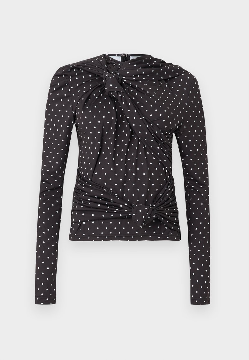 Haut noir à manches longues avec des pois blancs, un devant torsadé avec un détail de nœud, et un tissu doux et extensible pour le confort.