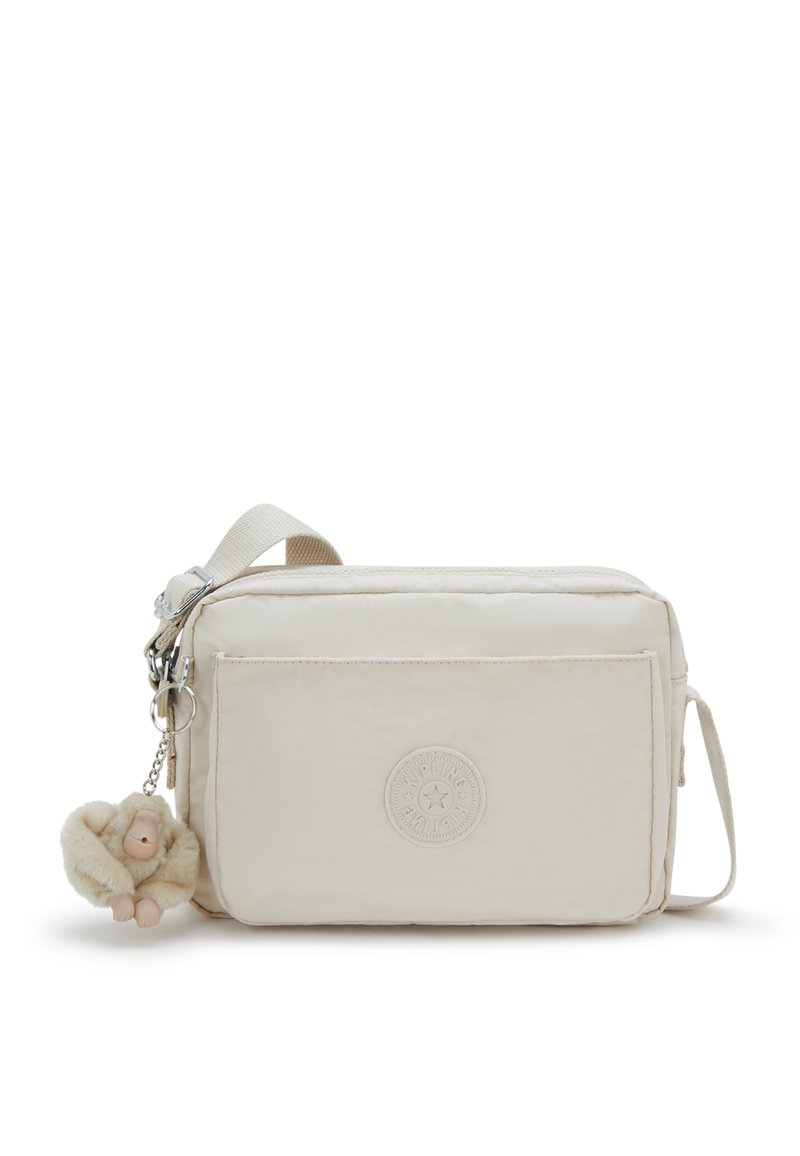 Beige Umhängetasche aus leichtem Stoff, mit einer strukturierten Oberfläche, Fronttasche, Logo-Patch und einem flauschigen Affen-Schlüsselanhänger.