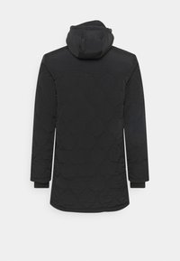 Parka nera imbottita con un design trapuntato caratterizzato da motivi circolari, maniche lunghe e cappuccio. Tessuto liscio con polsini a coste.