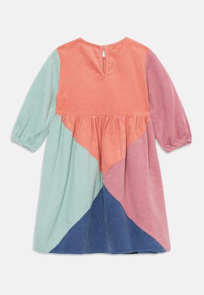 Colorful corduroy dress with long sleeves. Features a geometric patchwork design in peach, blue, green, and purple. Keyhole back closure.