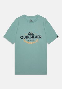 Light teal short-sleeve t-shirt made of soft cotton featuring a large Quiksilver logo in black and orange with a mountain graphic.