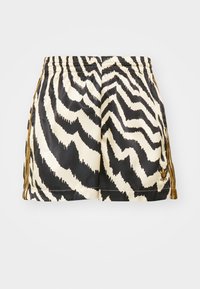 Svarta och krämfärgade shorts med ett zickzackmönster, elastisk midja och guldiga detaljer på sidorna. Tillverkade av glatt tyg.