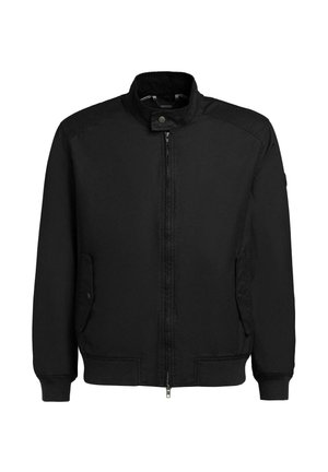 Sort glidelåsjakke med ståkrage, to frontlommer med klaffer og knapper, og ribbestrikkede mansjetter og nederkant.