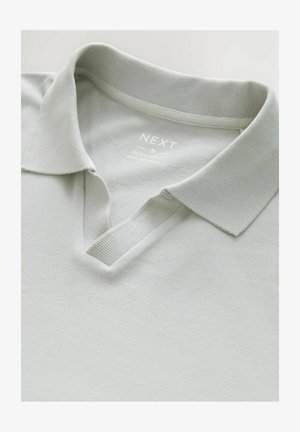 Light gray polo shirt with a knitted texture, featuring a classic collar and a v-neck design. Fabric label states "NEXT, M, Regular Fit."