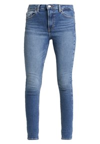 Tight jeans i medelblå denim, med en klassisk femficksdesign och subtila blekningar på låren, med en mjuk textur.