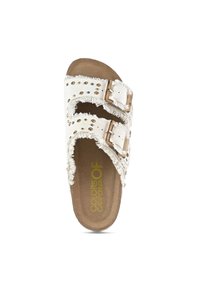 White slide sandal with frayed edges, dual buckles, and studded accents. Contains a brown cushioned footbed for comfort.