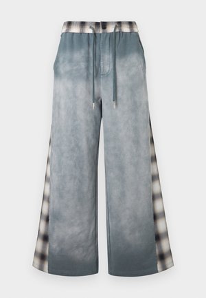 Wide-leg grey pants with drawstring waist and plaid patterned side panels, combining casual and stylish design elements.