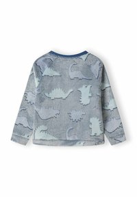 Pull en polaire de couleur gris clair orné de motifs de dinosaures bleus. Texture douce, manches longues et col rond.