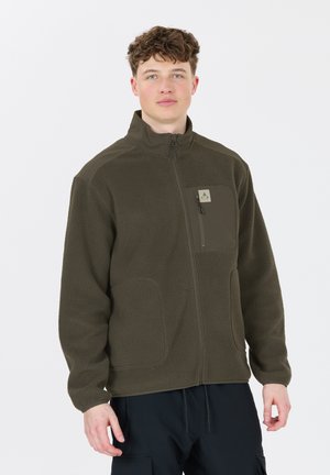 Olive green fleece jacket with a high collar, zippered front, and chest pocket, featuring textured fabric and a logo patch on the chest.