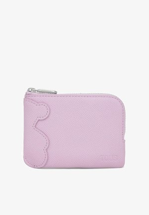 Small lavender zippered wallet with textured surface and scalloped edge detail on the left side, embossed brand name in bottom right corner.