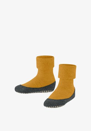 Gelbe gestrickte Socken mit umgeschlagenem Bündchen und grauen strukturierten Sohlen, die mit weißen Gummipunkten für besseren Halt versehen sind. Weicher, gemütlicher Stoff.