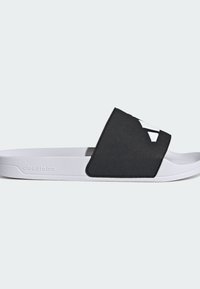 Black slide sandal with a textured upper and white cloudfoam sole. Features a minimal design and a prominent logo detail on the strap.