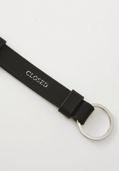 Black leather strap keychain with a silver metal ring. The strap features embossed "CLOSED" text, with a smooth texture and minimal design.