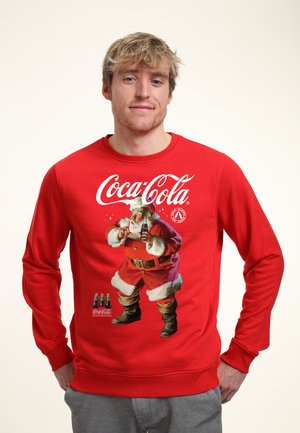 Rode sweatshirt met een Coca-Cola logo en een afbeelding van de kerstman. Zachte stof met lange mouwen en geribbelde manchetten.