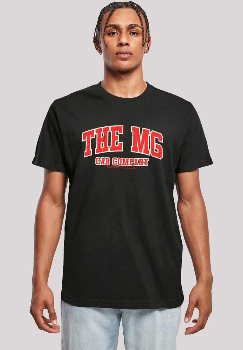 Black cotton T-shirt featuring bold red text "THE MG CAR COMPANY" across the chest, crew neck, and short sleeves. Simple, casual design.