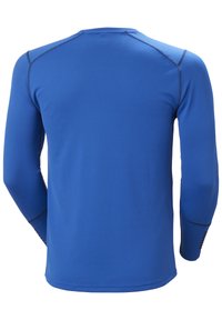 Langarm sportshirt in felblauw. Gemaakt van gestructureerde stof met contrasterende donkere naden en een ronde halslijn. Heeft aangesloten mouwen.
