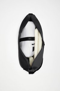 Črna torbica z zadrgo, z gladkim, mat zaključkom. Vsebuje bel flis kos in kremasto, rebrasto dodatno opremo.