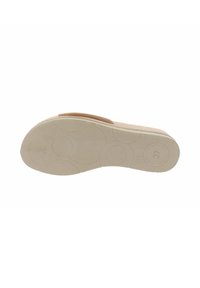 Sandale beige avec une semelle lisse et rembourrée présentant des motifs circulaires et un bout arrondi. Taille marquée comme 37 au fond.