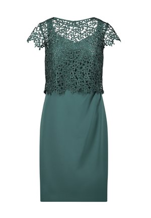 Donkergroene jurk tot op de knie met een bloemenkantoverlay op het lijfje en kapmouwtjes, ronde halslijn en een ritssluiting aan de achterkant.