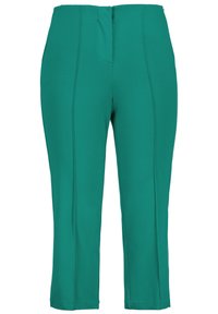 Vihreät, räätälöidyt housut joustavasta kankaasta. Ominaisuuksiin kuuluu keskipitkä vyötärö, pystysaumat ja lyhyet lahkeet. Ei näkyviä taskuja tai metalliosia.