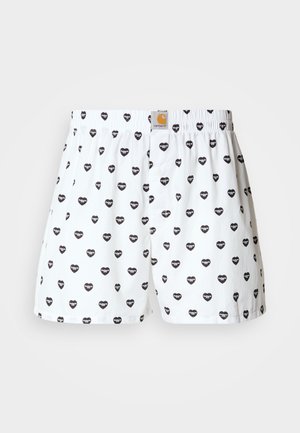 Hvite boxershorts med et mønster av små svarte hjerter. Har elastisk linning og knappelukking. Glatt bomullsmateriale.