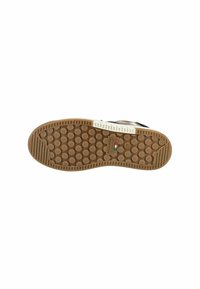 Brown rubber outsole featuring a textured, dotted pattern with a white accent and branding detail. Design focuses on traction and durability.