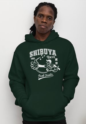 Felpa verde con cappuccio caratterizzata da una stampa grafica di un giocatore di baseball e testo che recita "Shibuya 1961 Tokyo Park Fields" in bianco, con tasca a canguro.