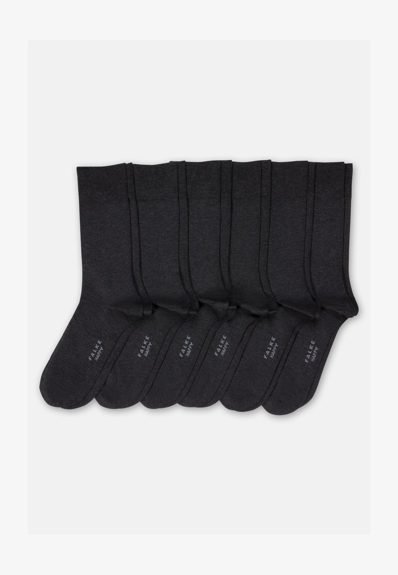 Sept paires de chaussettes noires mi-mollet alignées soigneusement, chacune avec "FALKE HAPPY" imprimé en blanc sur la semelle.
