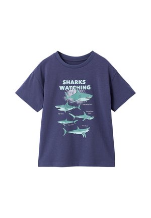 Navy blue T-shirt with shark illustrations and labels beneath "Sharks Watching" text, featuring five shark species.