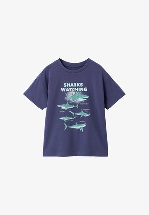 Navy blue T-shirt with shark illustrations and labels beneath "Sharks Watching" text, featuring five shark species.