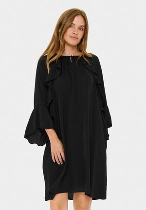 Black dress with a loose fit, featuring ruffled accents along the front and sleeves, round neckline, made of lightweight fabric.