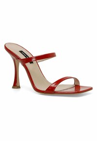 Red patent leather high-heeled sandal with two narrow straps across the foot, square toe, and a curved stiletto heel.