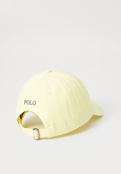 Geltonas medvilninis kepurė su kreivu kraštu, reguliuojama dirželiu ir siuvinėtu "POLO" logotipu ant nugaros. Lygi tekstūra, kasdienis dizainas.
