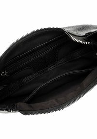 Black leather bag interior with zip pocket, textured lining, and smooth fabric compartments, featuring a zip closure along the top edge.