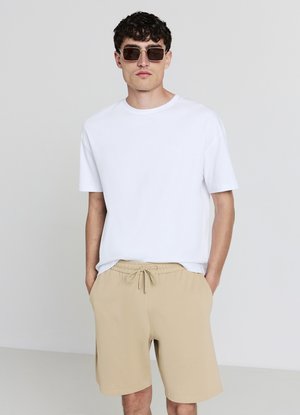 GINNICO - Tracksuit bottoms - beige