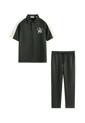 Polo vert foncé à manches courtes avec empiècements blancs aux épaules et logo floral, associé à un pantalon à cordon assorti.
